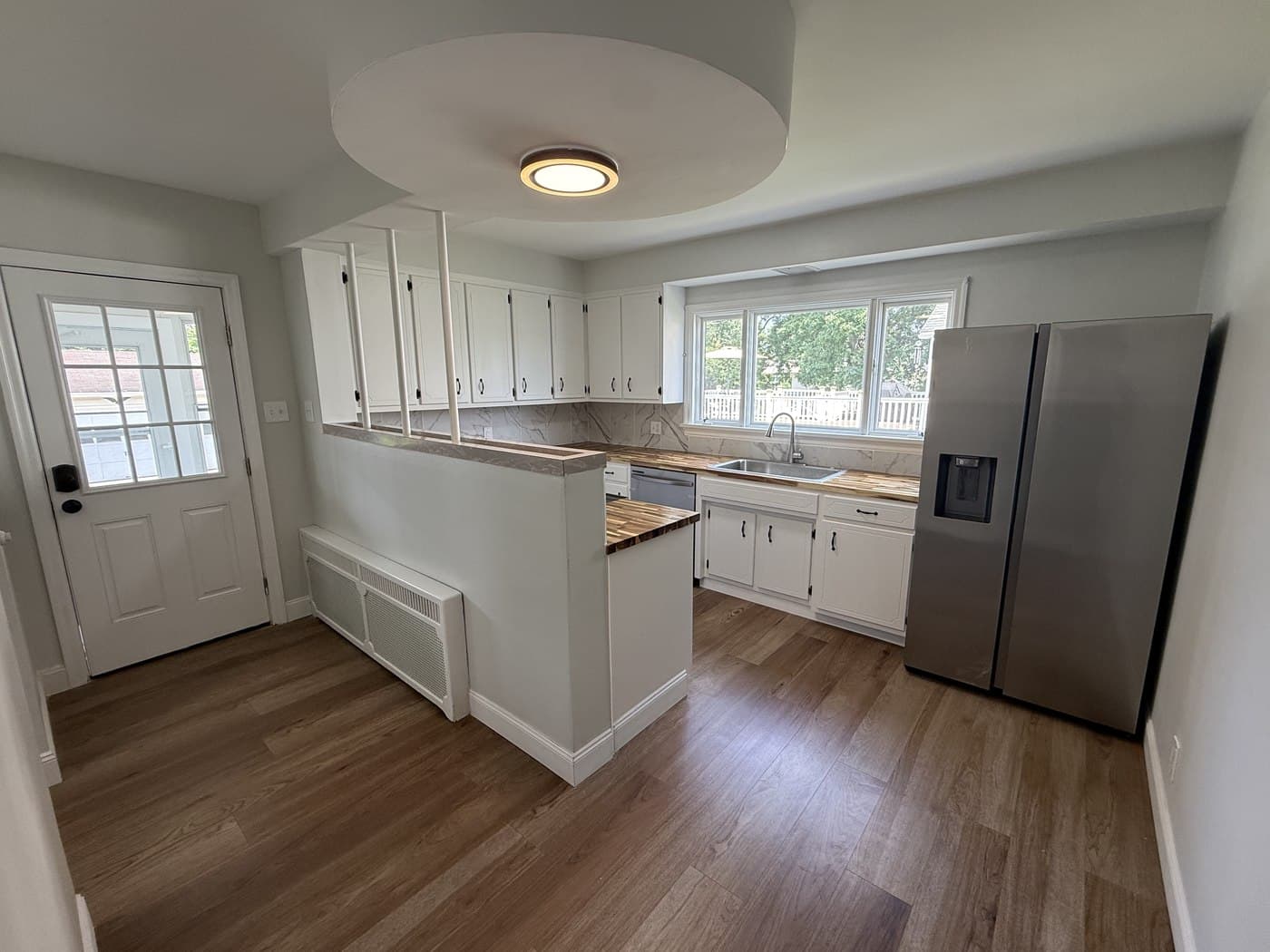 Renovated kitchen at 4036 Birney Avenue in Moosic, Pennsylvania, with white cabinetry and wood countertops